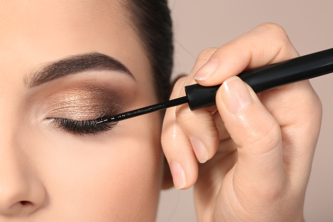 Artist Applying Eyeliner to Woman